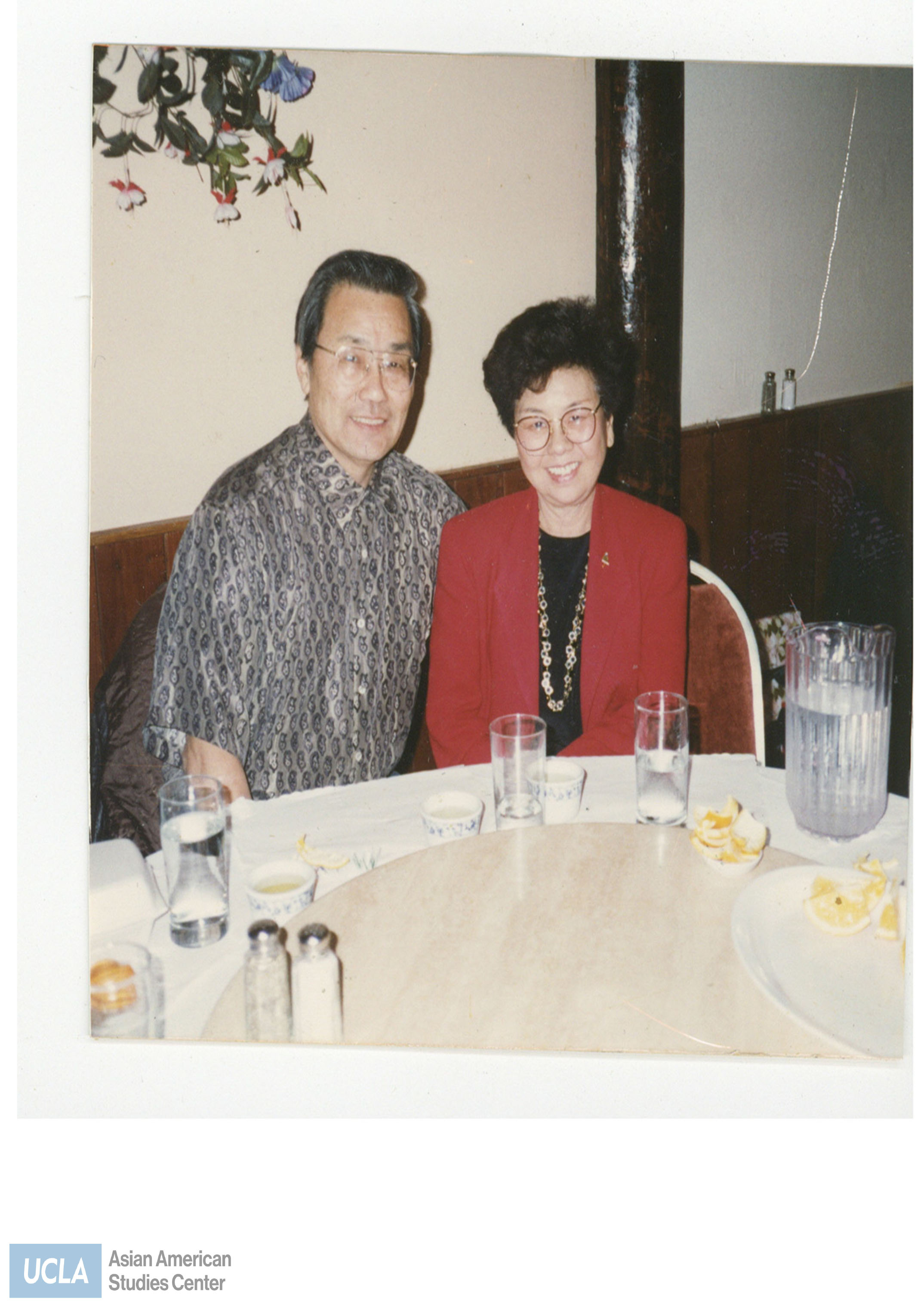 Photo of John and Kathy Shigemoto sitting at a table in restaurant. Back photo text: 