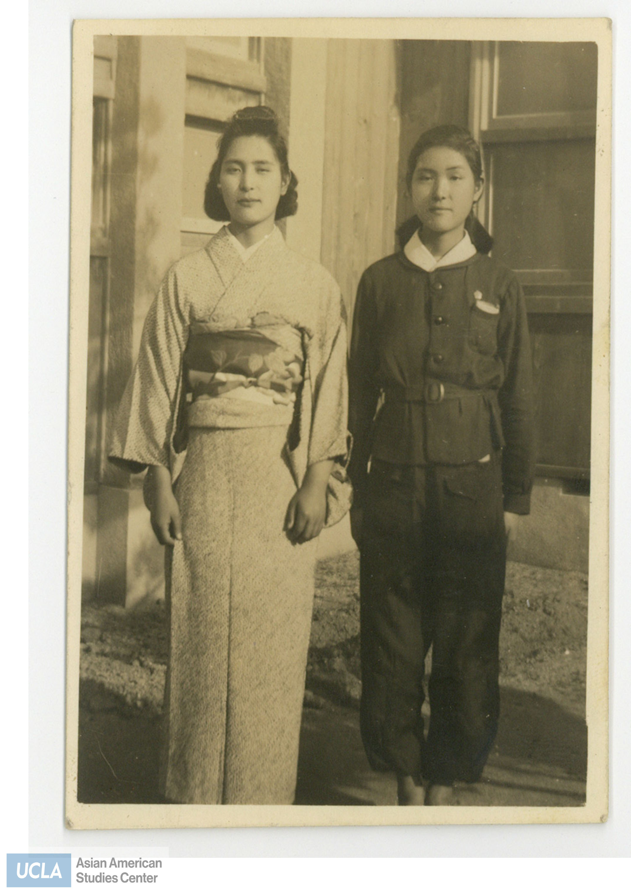 Photo of two women. The woman on the left is wearing a kimono. Back of photo contains the year 1946 and writings in Japanese.