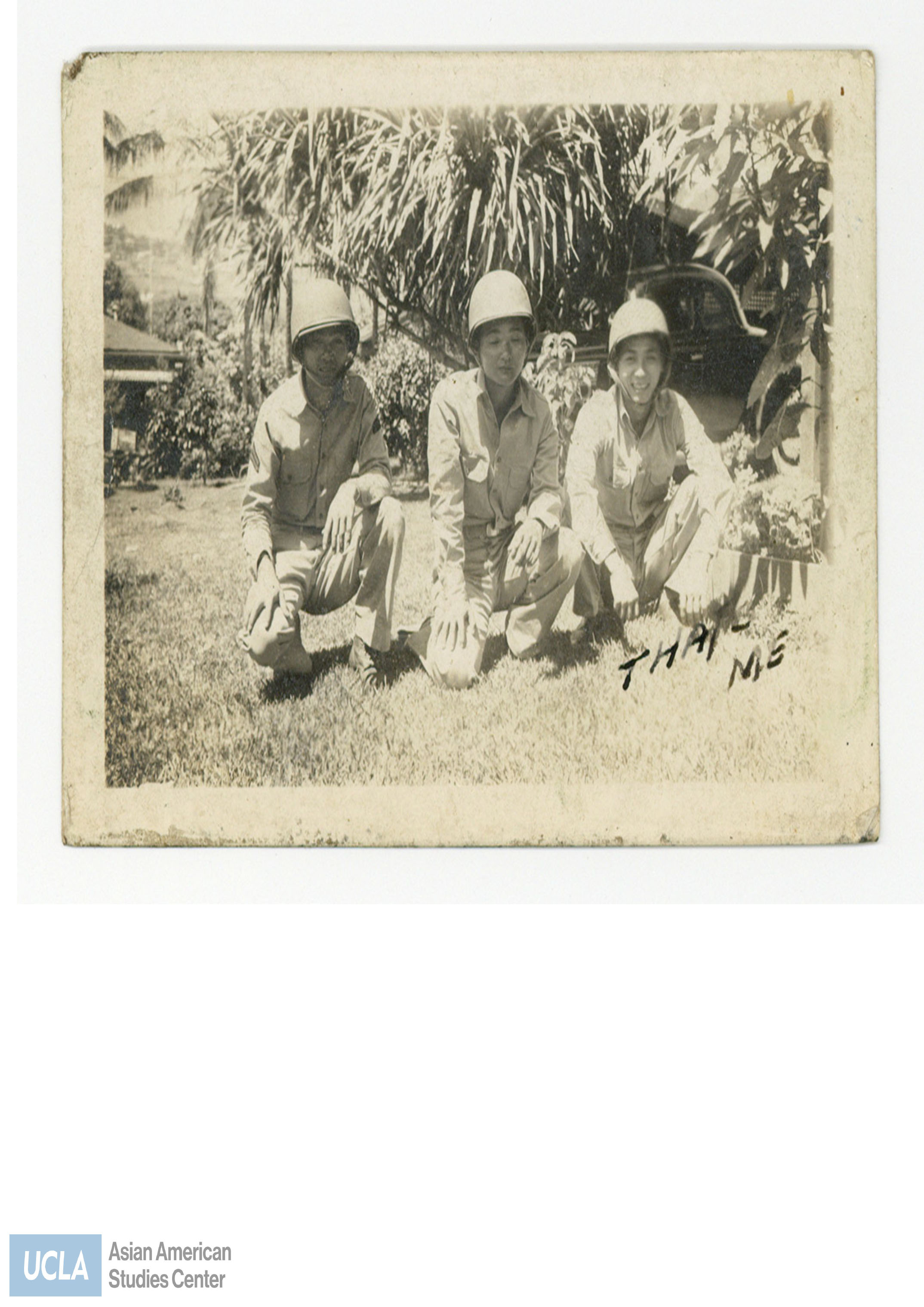Photograph of three Nisei soliders kneeling. Back of photo includes text: 