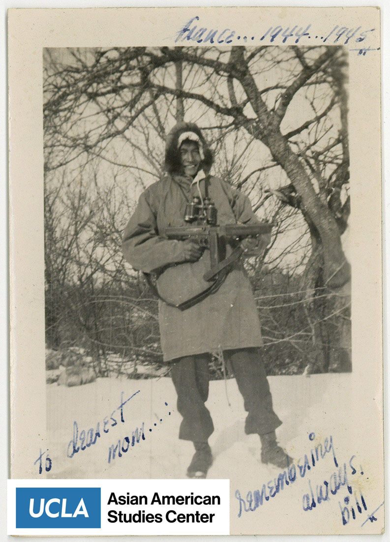 Bill wearing a winter coat standing in snow with a gun. Includes text: 