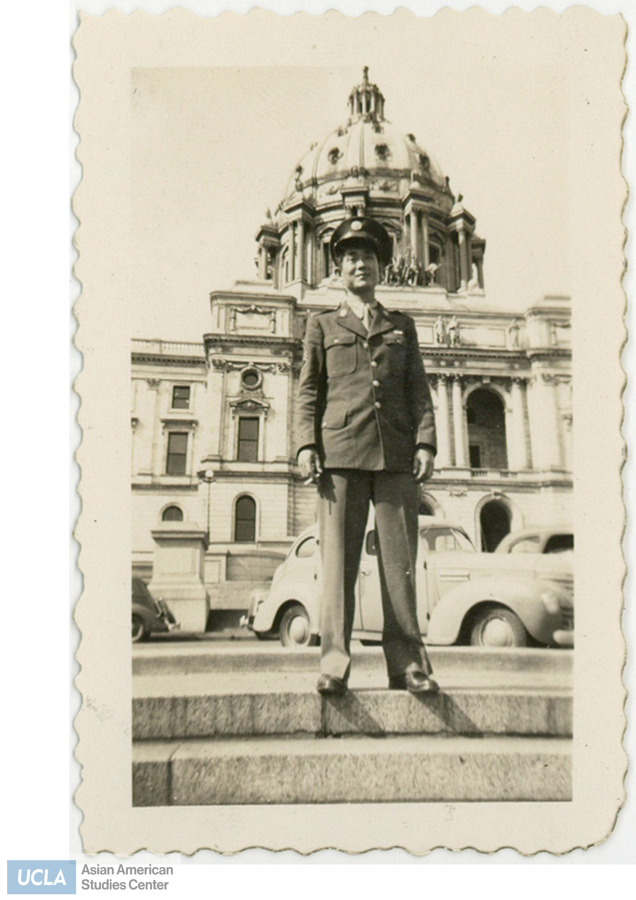 Nisei solider standing infront of a domed building.