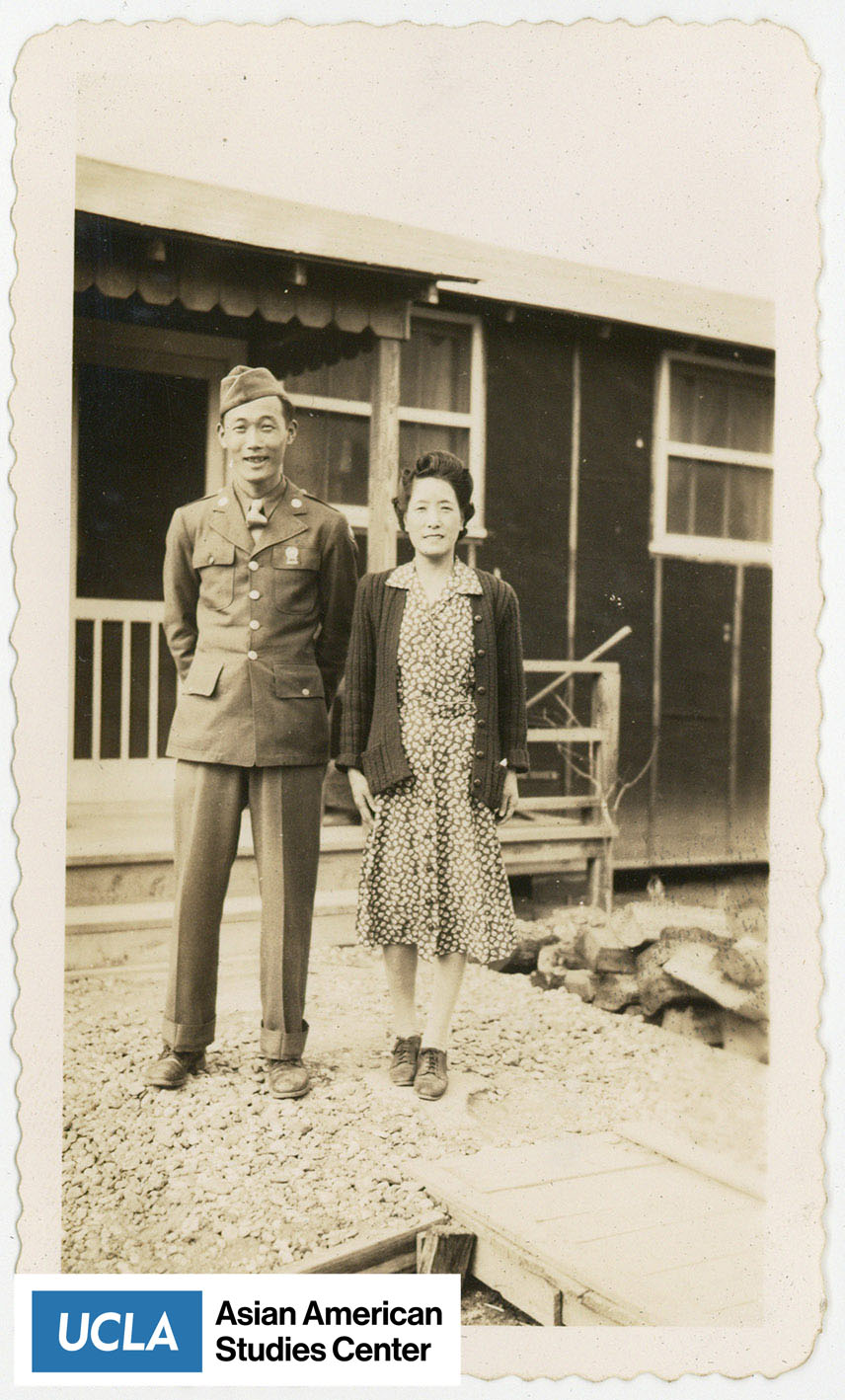 Tsuma Nakahara standing next to a Nisei serviceman.