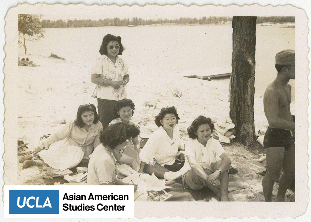Nisei women relaxing by a lake.