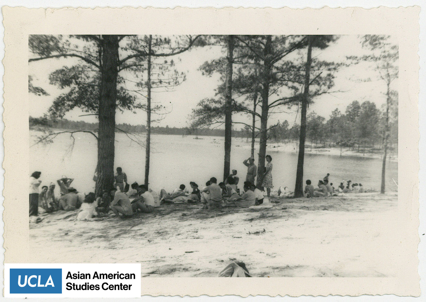 Nisei women and Nisei soldiers by a lake.