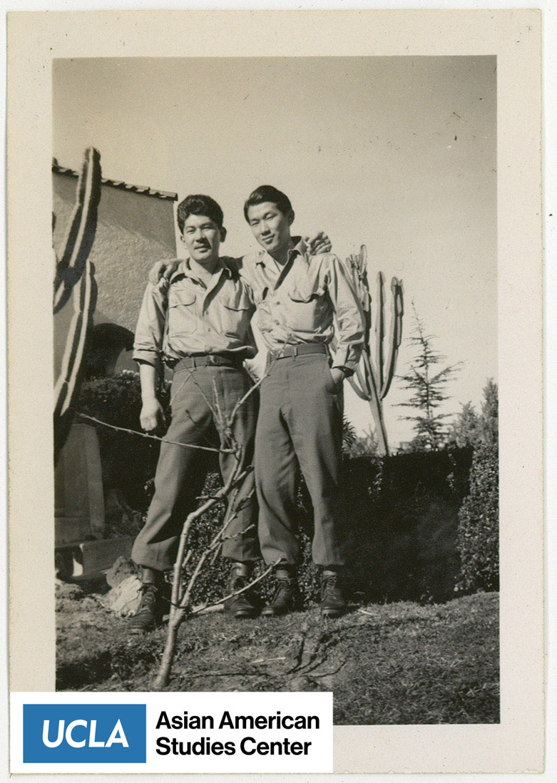 Two Nisei men pose for a photograph.