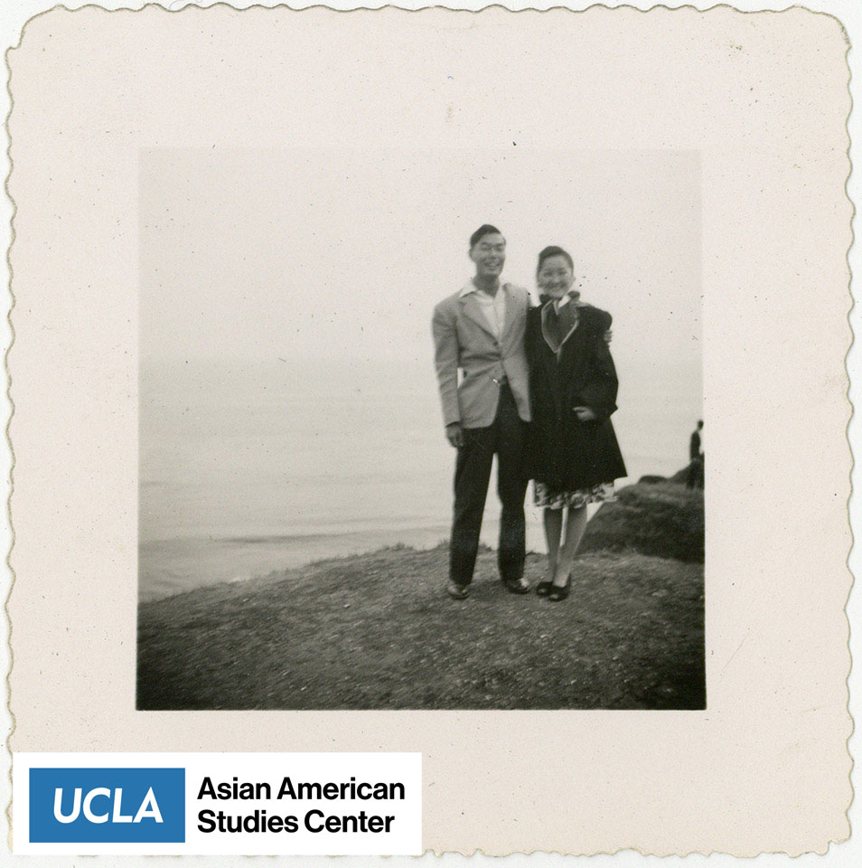 Pete and wife stand before a body of water.