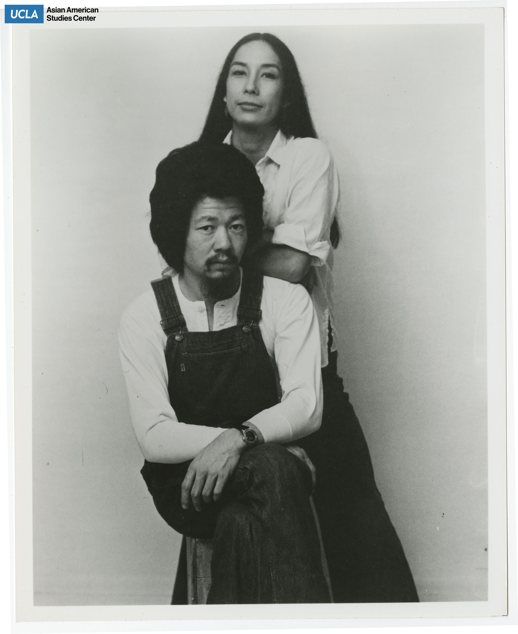 Nobuko Miyamoto stands behind a sitting Benny Yee.