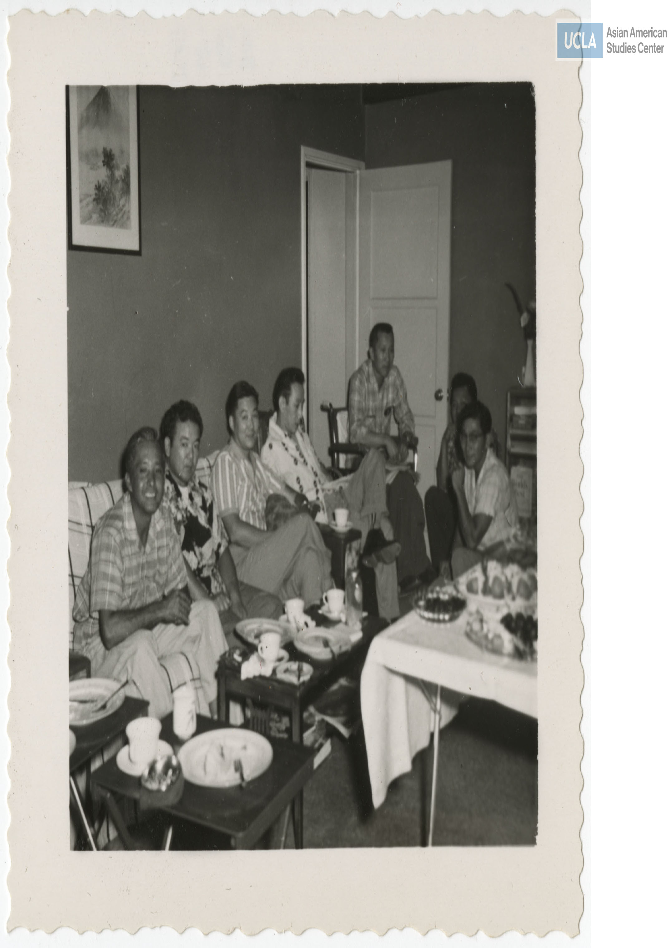 Men sitting and smilling for a photograph after their meal.