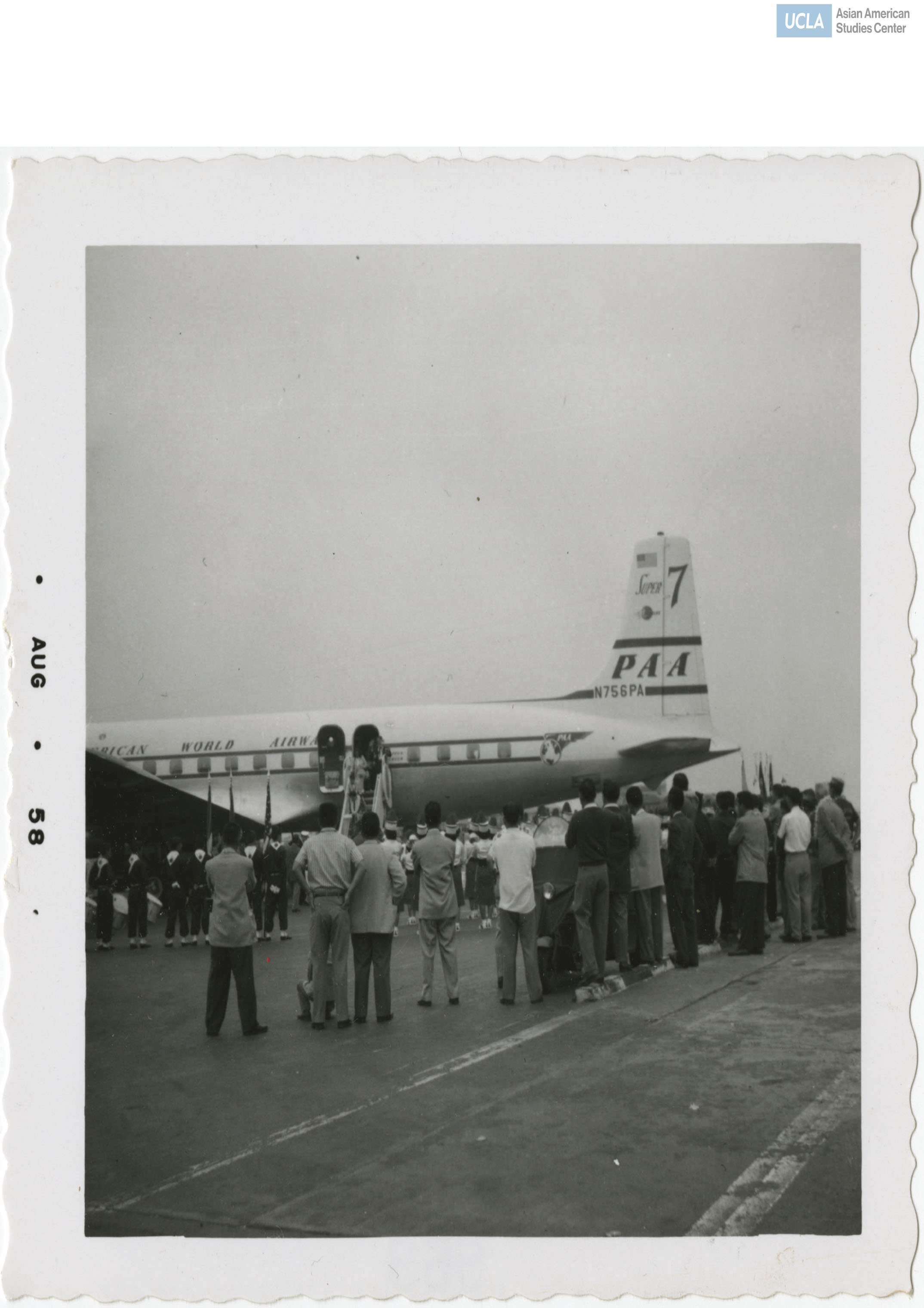 A marching band and a welcoming party greet attendees while deboarding the plane for the Nisei Veterans of Foreign Wars reunion.