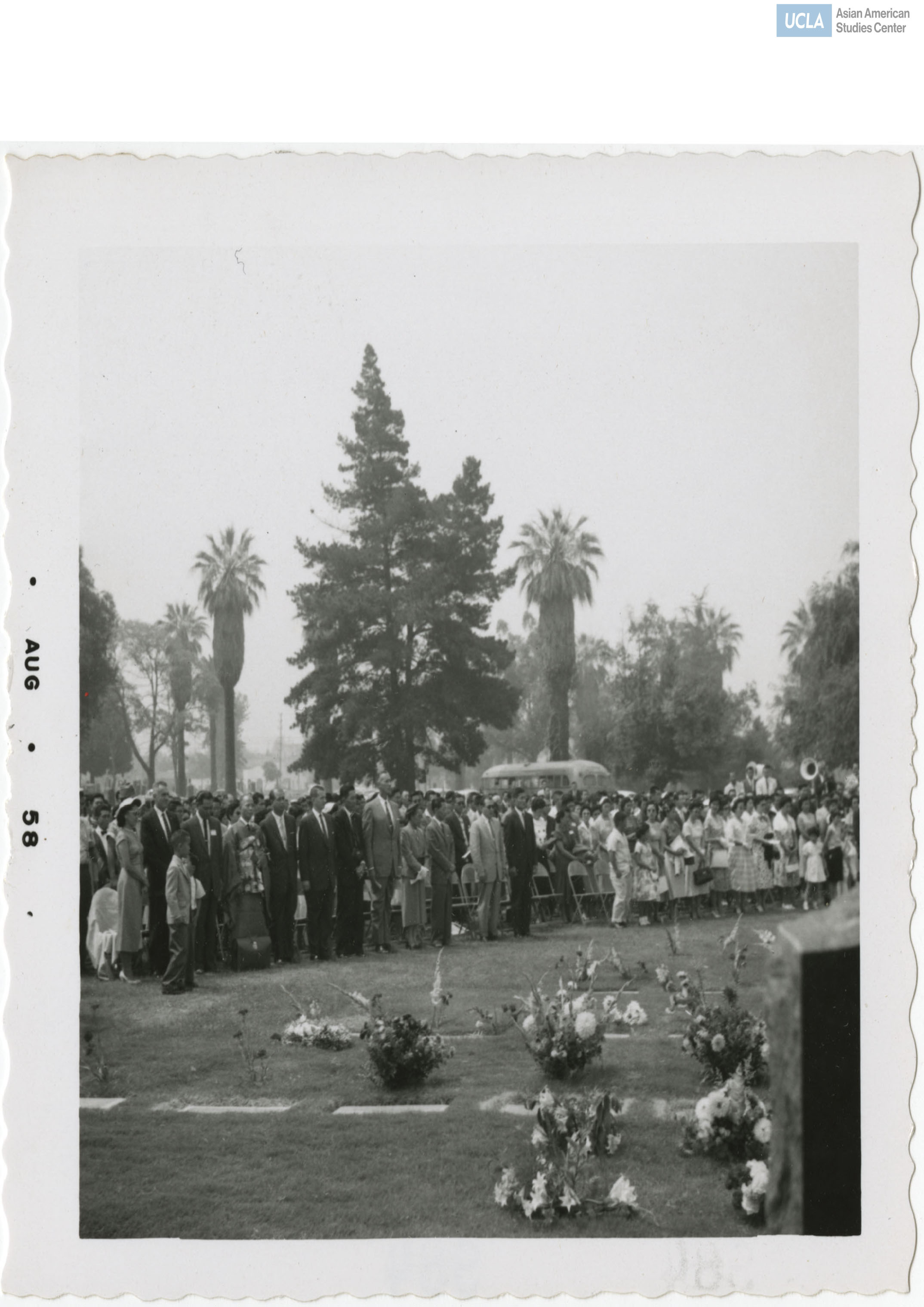Attendees stand for 442nd Regimental Combat Team reunion at Evergreen cemetary.