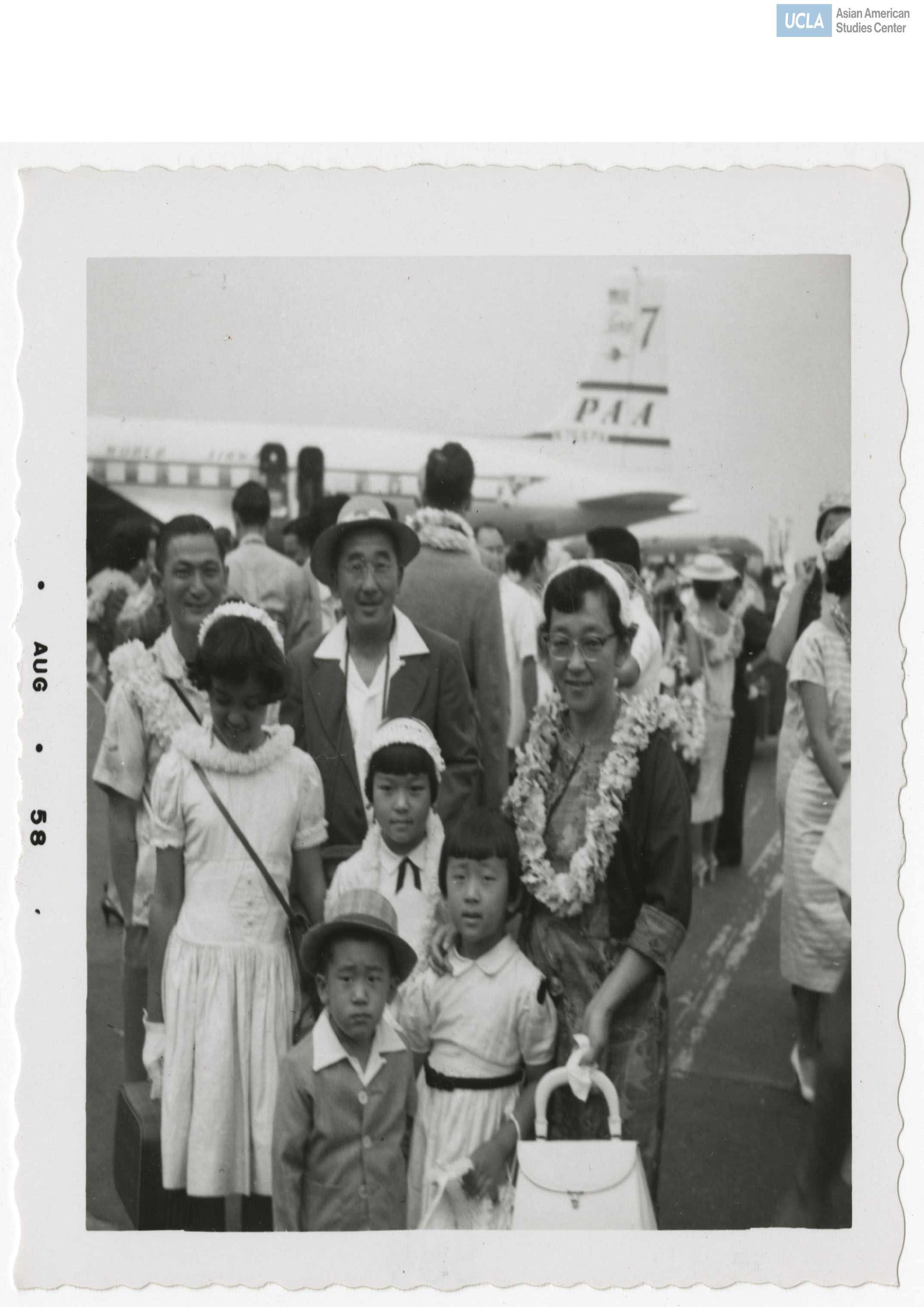 Family smiles while wearing lei for the Nisei Veterans of Foreign Wars reunion.