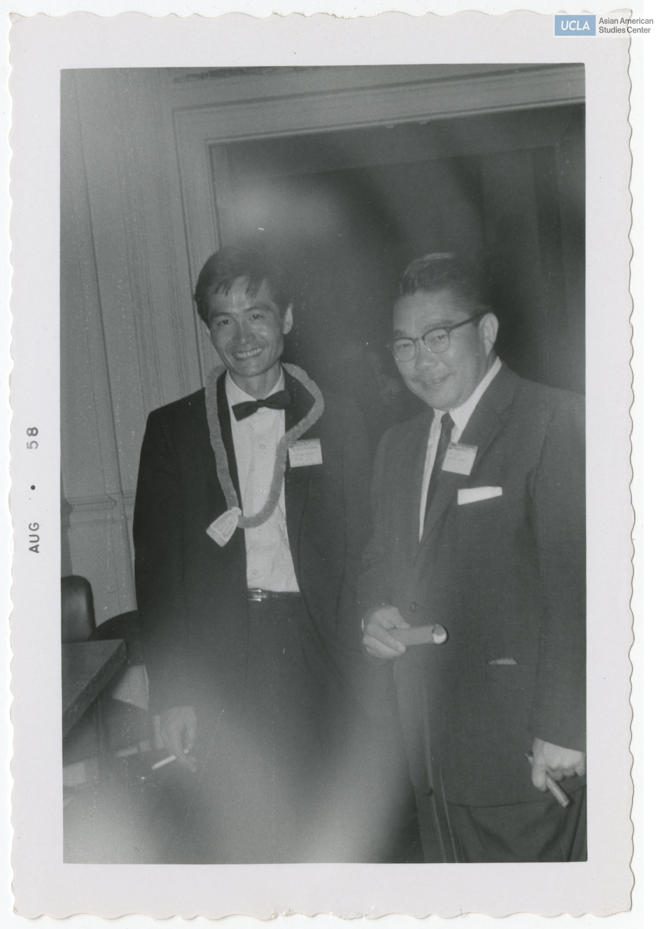 Bill Kochiyama in suit and bowtie with friend.