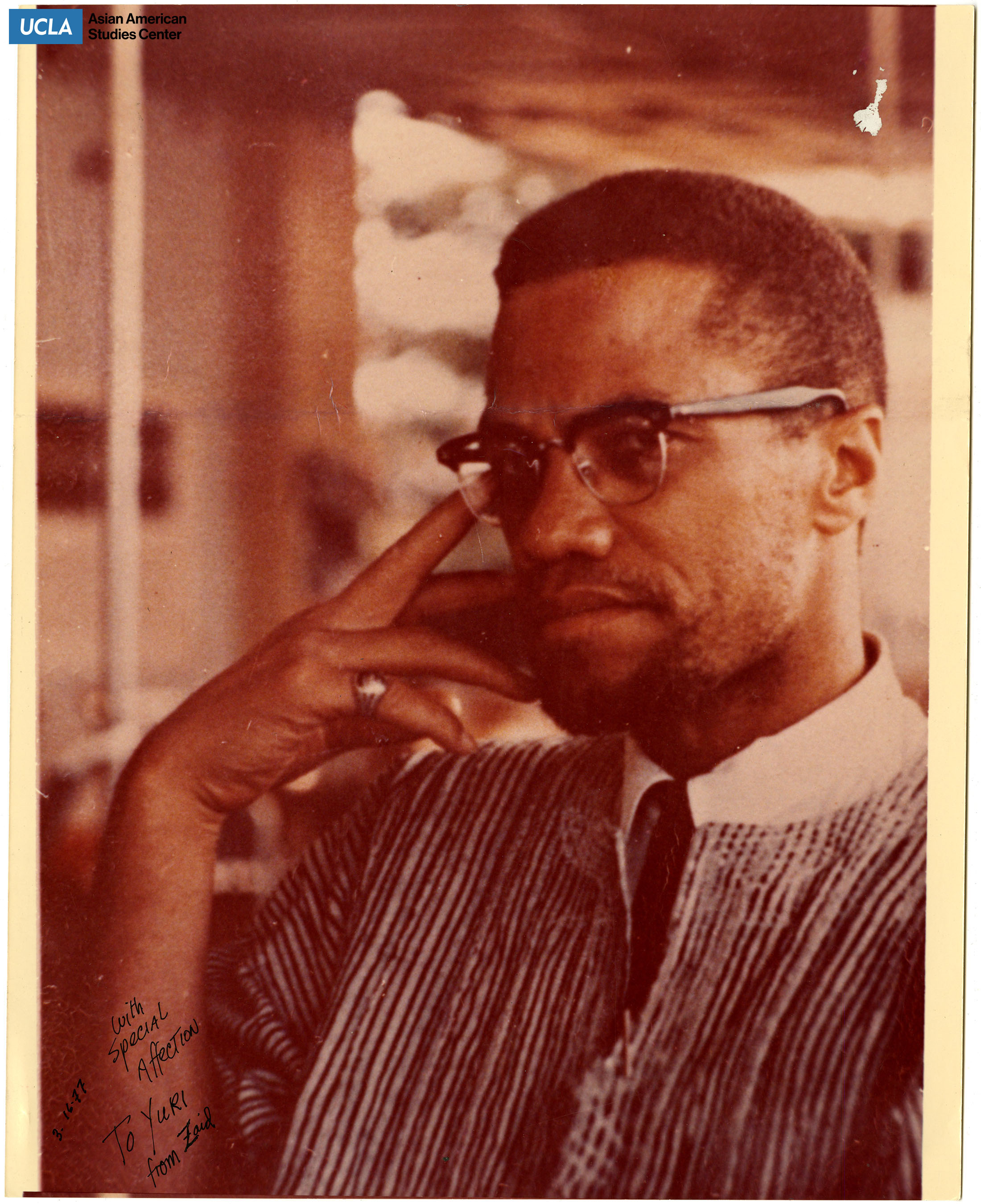 Photograph of Malcom X. Includes note to Yuri.