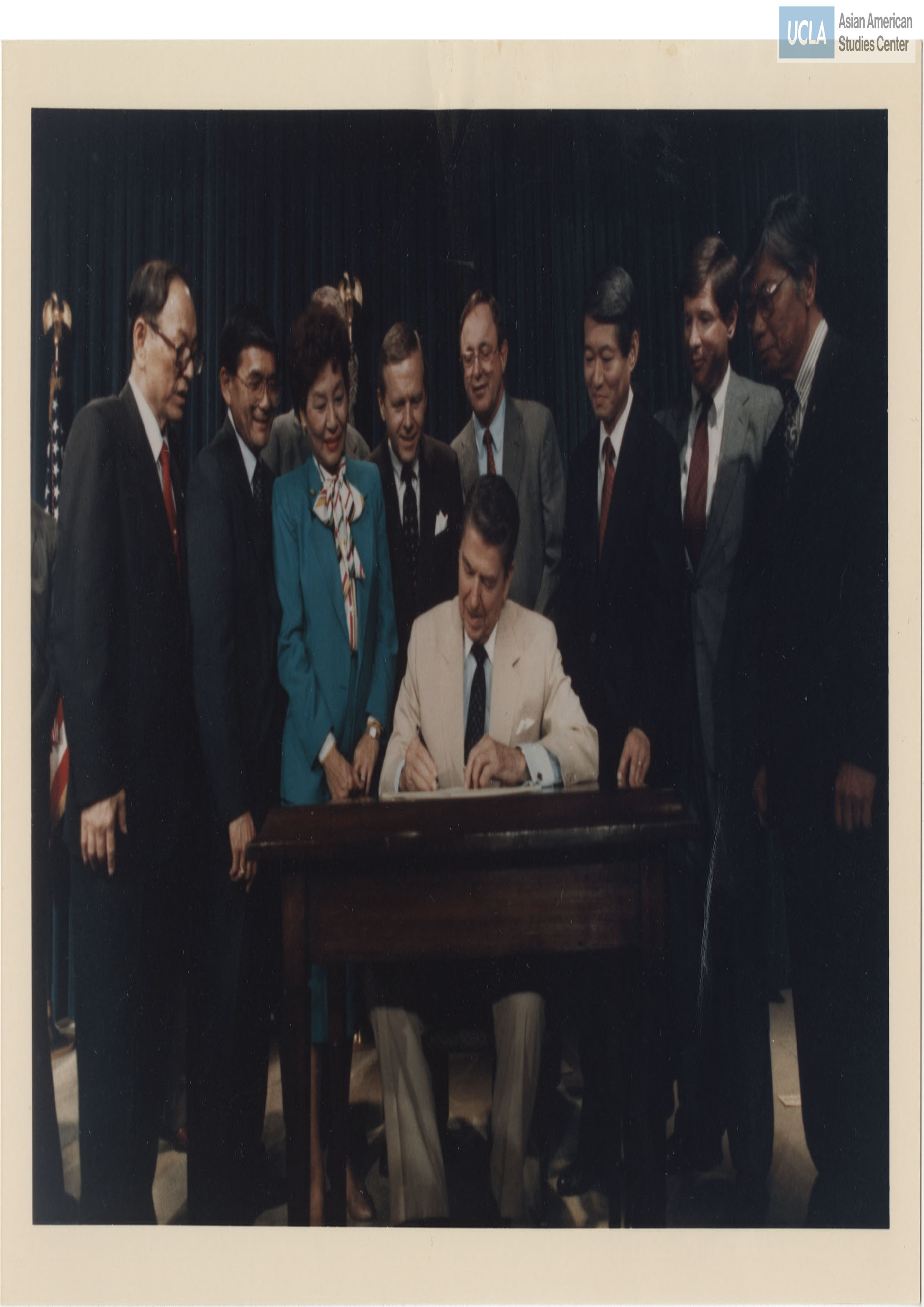 Photograph of President Ronald Reagan signing the redress bill, Civil Liberties Act of 1988.